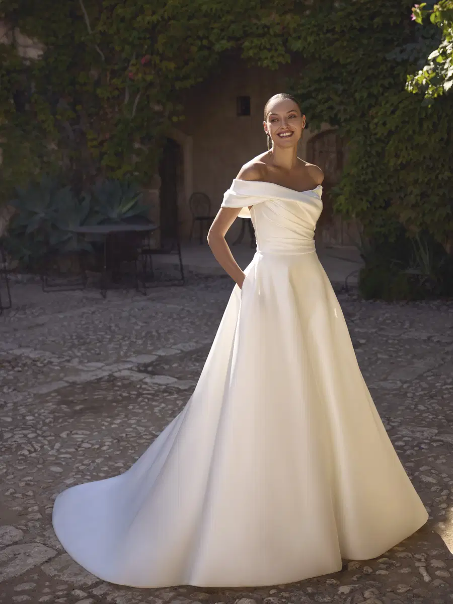 Gerlinde by Modeca Bridal: Ball Gown silhouette, off-shoulder neckline, satin, chapel train