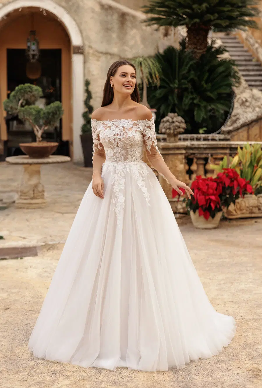 8334 by Monica Loretti: Ball Gown silhouette, off-shoulder neckline, long sleeves, lace