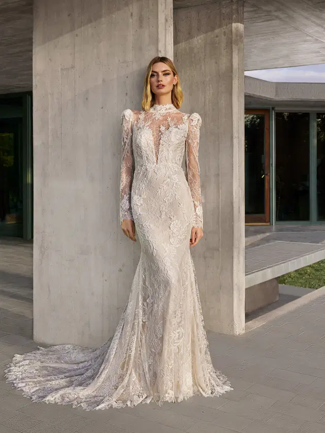 NOLEY by Pronovias: Mermaid silhouette, high neck neckline, long sleeves, lace