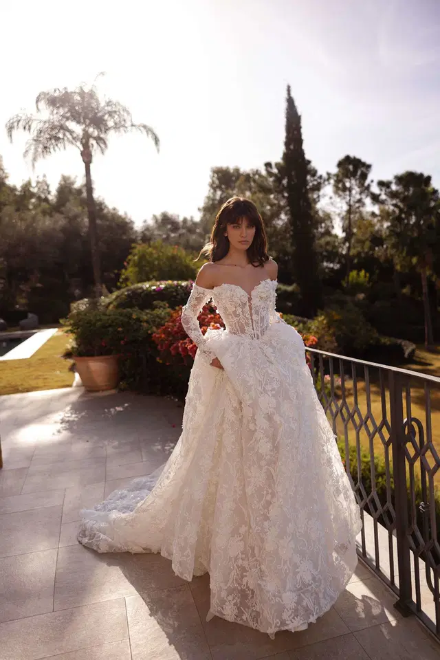 Celeste by Tina Valerdi: Ball Gown silhouette, off-shoulder neckline, long sleeves, lace