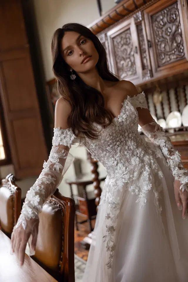 Freesia by Tina Valerdi: Ball Gown silhouette, off-shoulder neckline, long sleeves, tulle